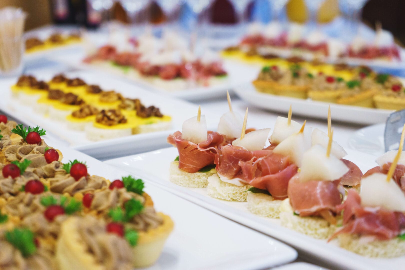 The classic Spanish tapas ham and melon. Food delivery service and catering meals on the table during the event. Soft focus.
